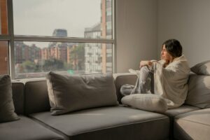 woman at home wrapped in blanket